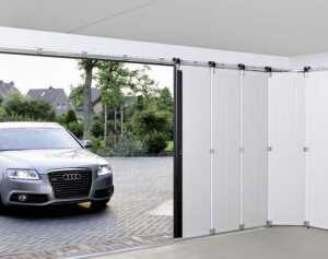 silver audi car pulling into an automated garage door